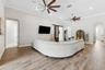 Spacious living room with dual oversized fans.