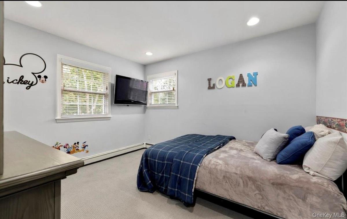 Bedroom featuring carpet, baseboard heating, and recessed lighting