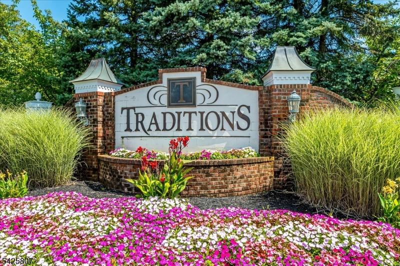 Traditions Sign and Flowers