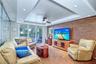 The living area is elevated by softly illuminated tray ceilings that accentuate the expansive Gulf and beach vistas.