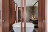 Full bath with a freestanding tub, tile walls, and vanity