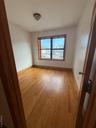 Unfurnished room with light wood finished floors and baseboards