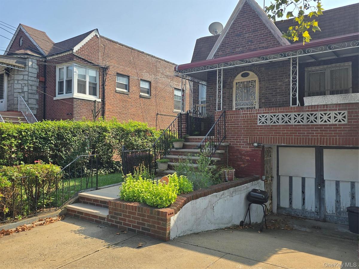 View of front facade featuring brick siding and covered porch