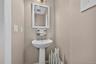 A convenient main-level half bath is tucked off the hallway for guests and everyday use. This completes the main level.