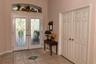 Tiled floor foyer 10-ft ceiling. The double entry leaded glass doors have a stunning radius window up top.