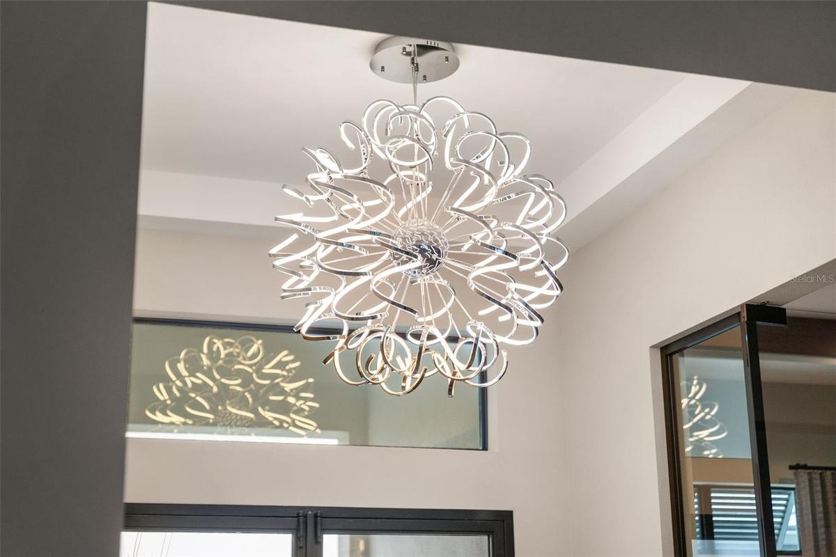 The foyer has soaring ceilings and designer lighting.