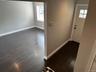 Entryway with baseboards and dark wood-style floors