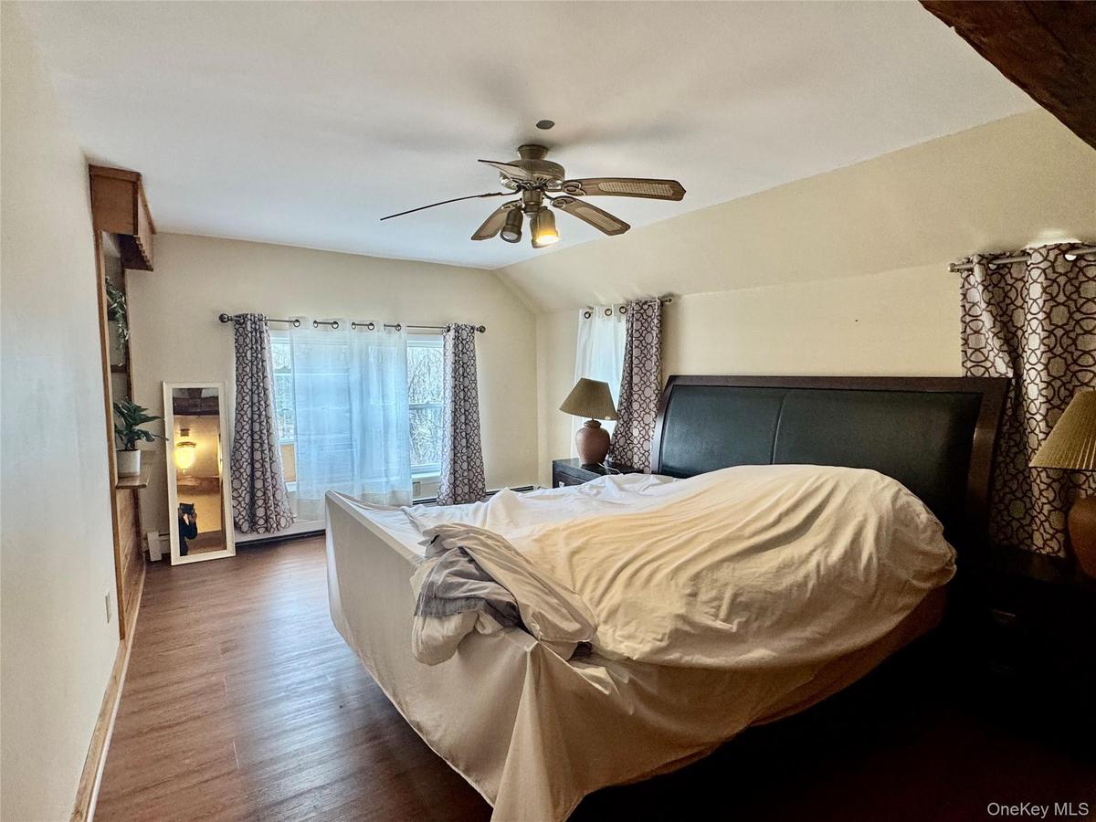 0  - master bedroom with lofted ceiling, wood finished floors, and a ceiling fan