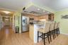 Walk through the front door from the West, past the primary bedroom, half bath and into the kitchen