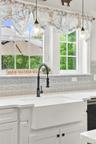 Deep farmhouse sink with backyard views