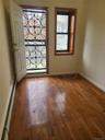 Entryway with wood-type flooring, baseboards, and baseboard heating