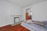 Bedroom with wood finished floors and baseboards