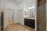 En suite primary bathroom with double sinks, walk in shower, and garden tub