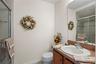 Full bath featuring a stall shower, vanity, and light tile patterned flooring
