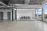 Unfurnished living room with elevator, concrete floors, and a city view