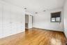 Unfurnished bedroom featuring light wood finished floors and ornamental molding