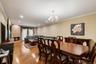 Hardwood flooring spans this open-concept room, featuring recessed lighting and crown molding