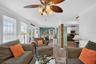 Alternate view of the living room flowing into the dining and kitchen areas.