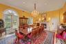 Dining room featuring a chandelier, crown molding, and a fireplace