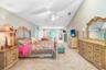 Expansive master bedroom 14' x 37' with vaulted ceilings and large sitting area and french doors out to pool/patio area.