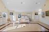Bedroom featuring inlaid floor details, high vaulted ceiling, and recessed lighting