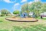 Community playground located across the street from the house.