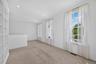 Large windows fill the upstairs bonus area with light, creating a peaceful spot to read, work, or unwind.
