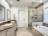 Primary ensuite bathroom with husge closet.