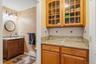 Lavatory at end of kitchen hallway.