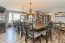 SPACIOUS Dining room featuring an inviting chandelier and light hardwood / wood-style flooring
