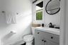 Full bathroom featuring vanity, a shower with curtain, and a baseboard radiator