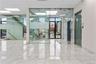 Unfurnished room with expansive windows, marble tiled floors, and a paneled ceiling