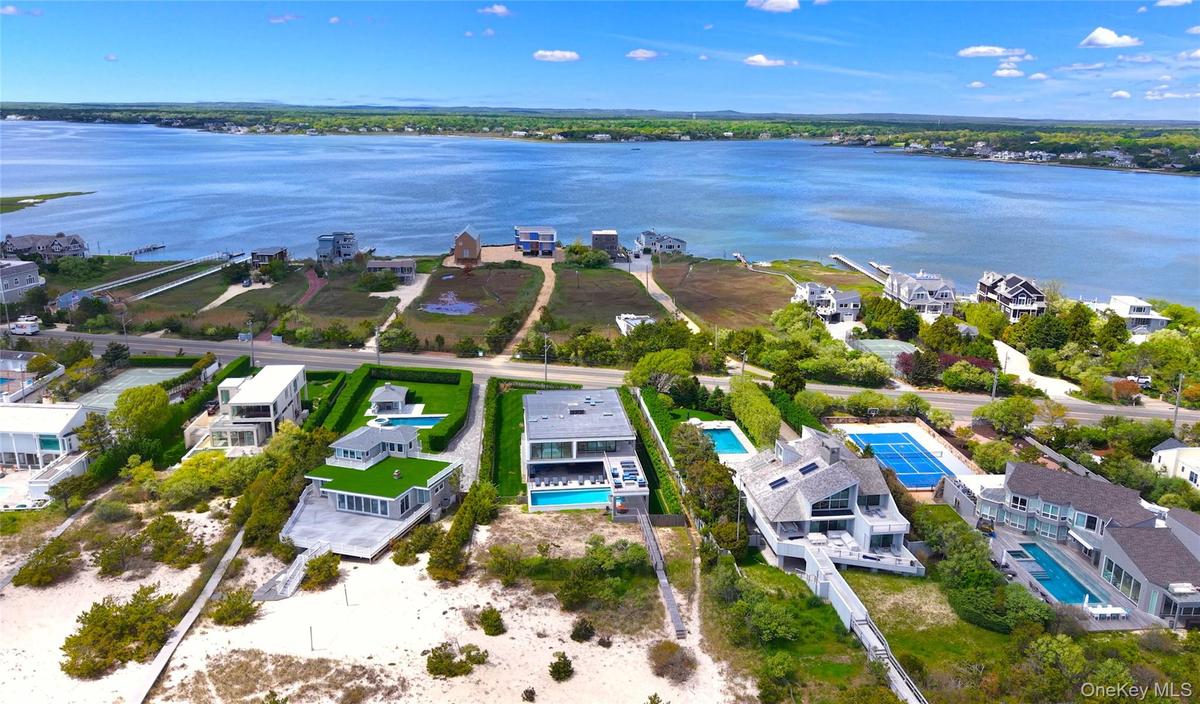 Aerial perspective of suburban area featuring a nearby body of water