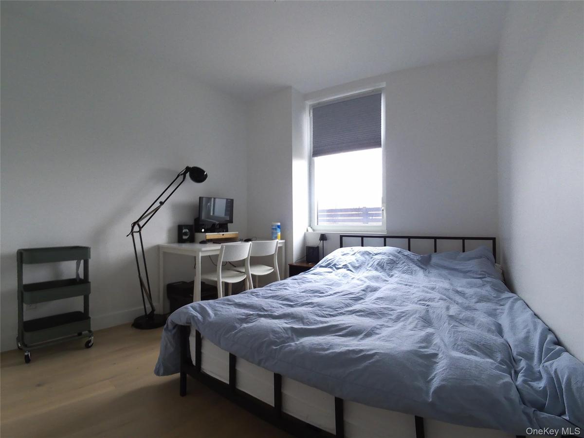 Bedroom with wood finished floors and baseboards