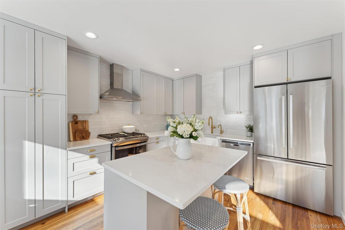 Kitchen featuring a breakfast bar, countertops, and stainless steel appliances