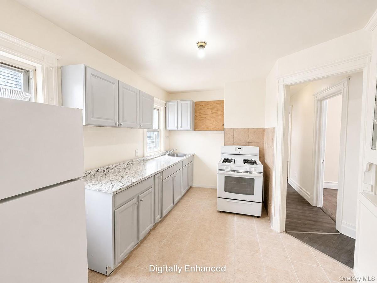 2nd fl Kitchen featuring light-toned cabinetry, a gas range, a white refrigerator, light-toned countertops, and a tiled floor