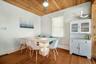 Dining area featuring wood-finish flooring and a distinctive wood-paneled ceiling