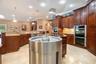 Custom Kitchen: Prep Sink, Snackbar, Custom Cabinets with under and over lighting, Hybrid Induction Cooktop, Hidden walk-in pantry