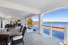 View of patio with a water view and outdoor dining space