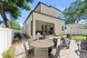 Fully fenced in backyard with a screened-in porch, paver patio for entertaining, professional landscaping, and irrigation system