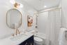 Full bathroom featuring toilet, shower / bath combo, and vanity