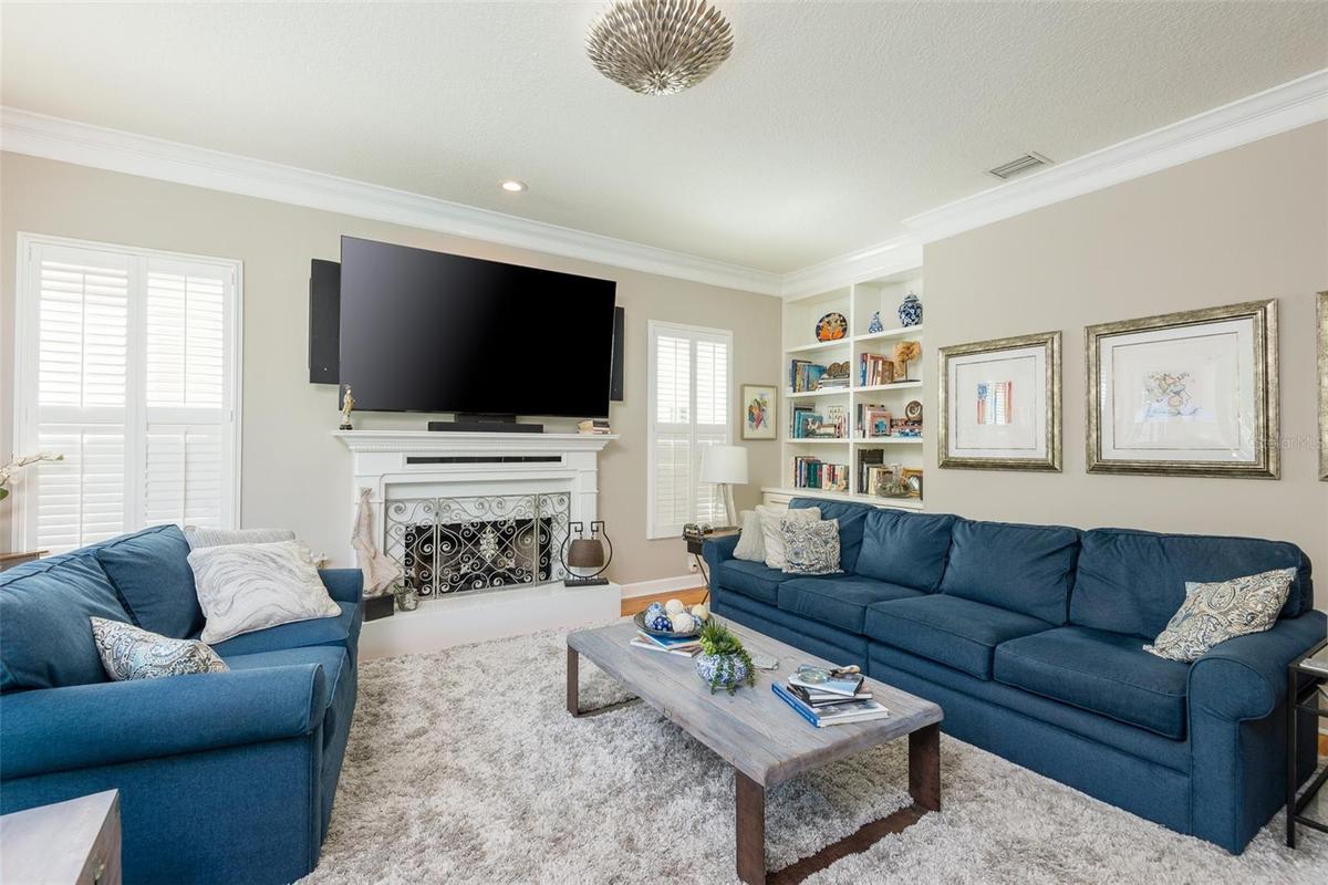 Living room with view of the built in bookcase (has access to water if you wold like a wet bar
