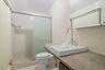 Full bathroom with a stall shower, tile walls, vanity, and light tile patterned floors