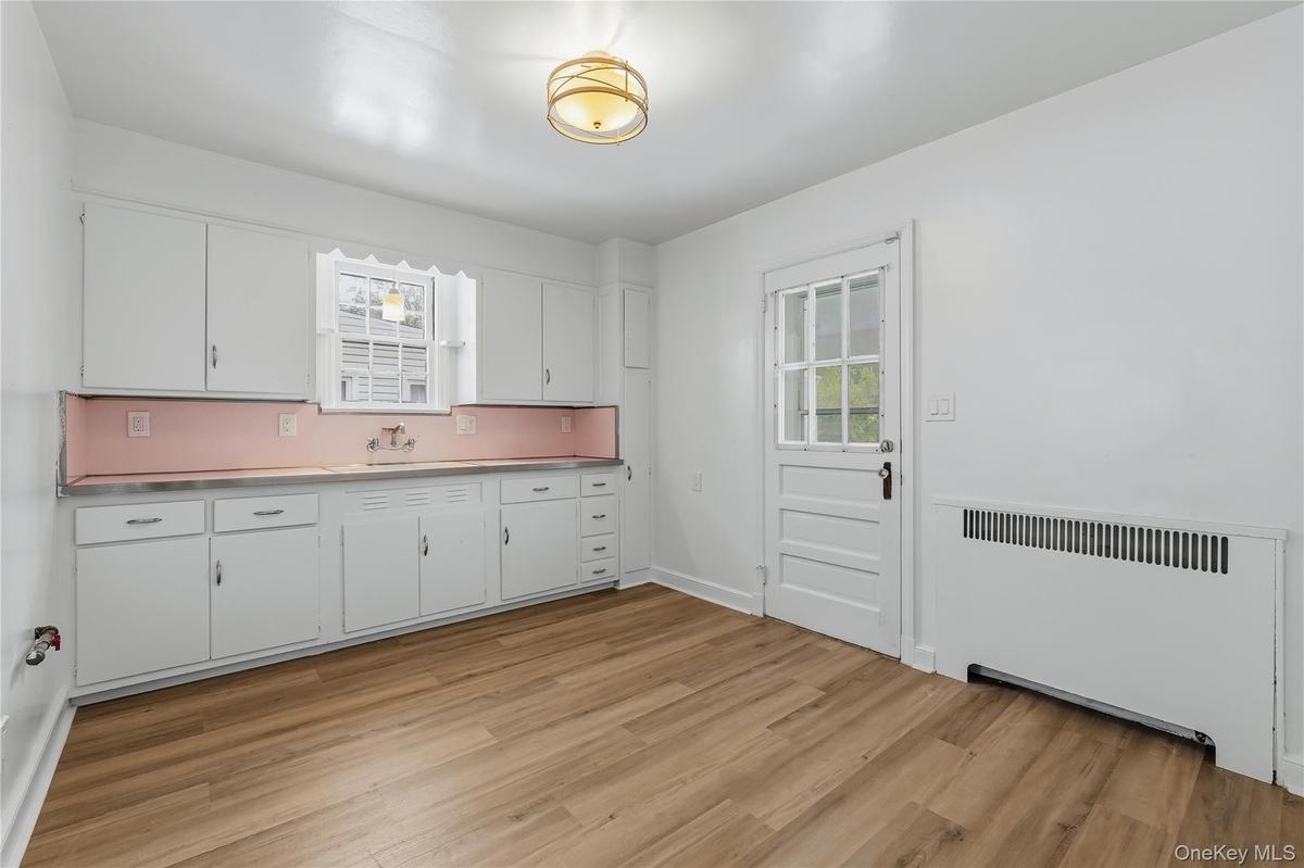 Kitchen with door to patio, yard and driveway