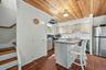 Kitchen with wood-finish ceiling, white cabinetry, and stainless steel appliances