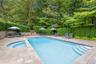 View of swimming pool with a patio, stairs, and a pool with connected hot tub