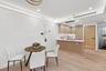 Dining room with light wood finished floors and recessed lighting