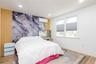 Primary Br,Feature wall with a gray and gold marble-patterned finish, complemented by a wood-finish accent panel