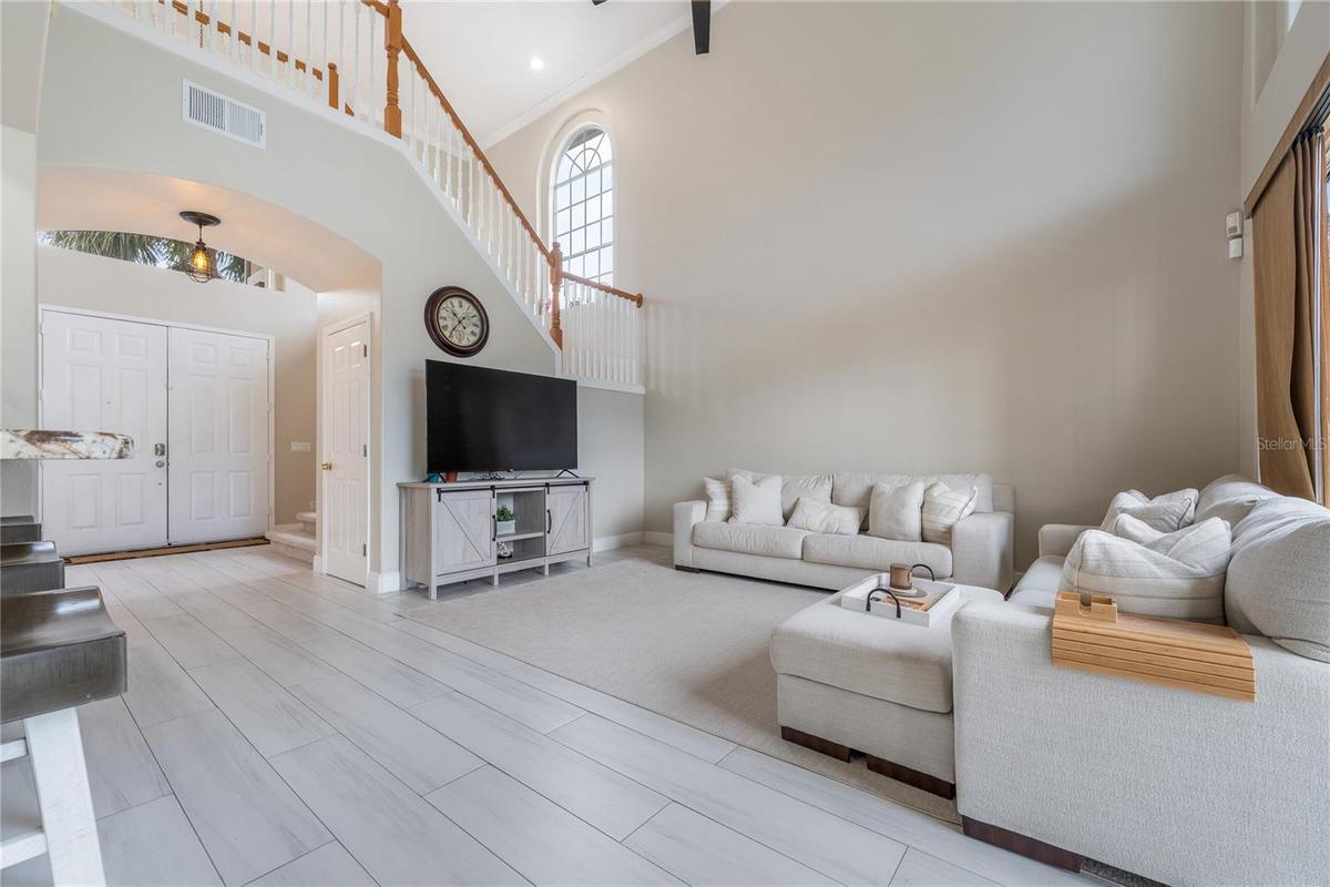 Large living area with high ceilings, ideal for entertaining and everyday living.
