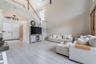 Large living area with high ceilings, ideal for entertaining and everyday living.